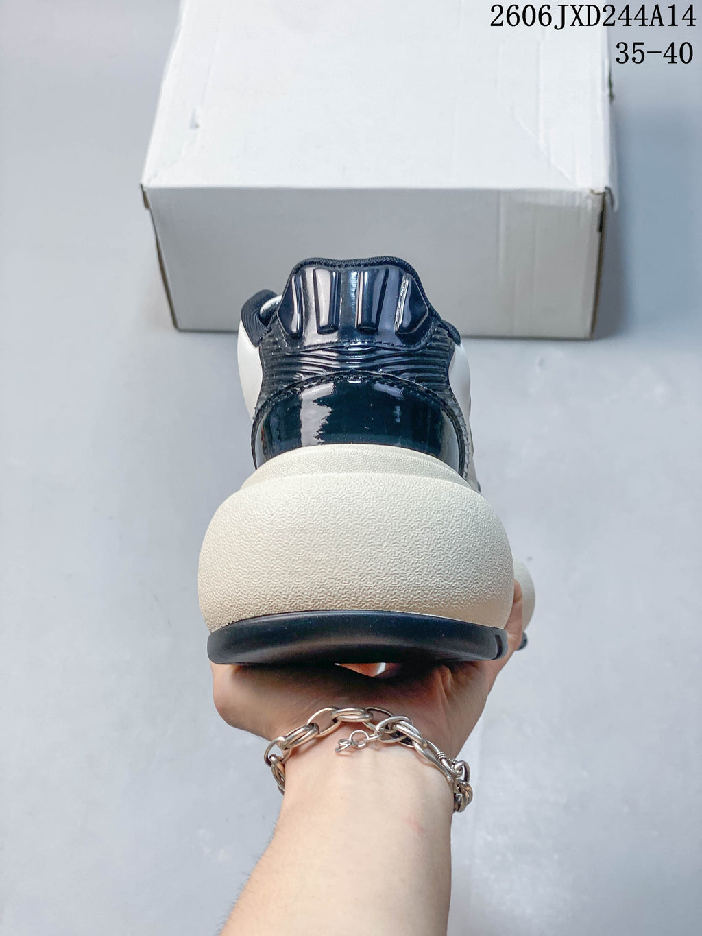 Rear view of an SMFK sneaker showing the navy heel detailing and chunky cream-colored sole