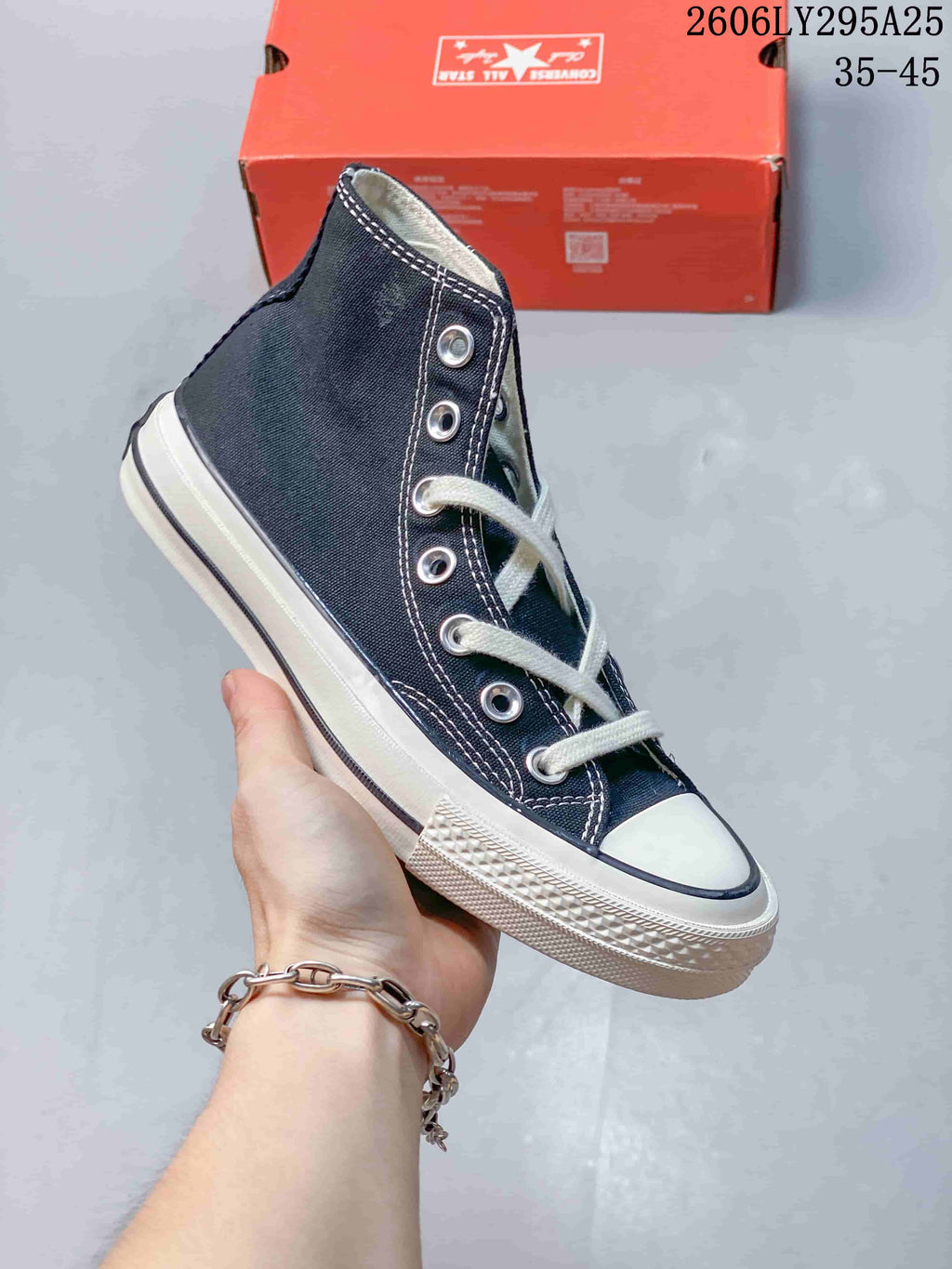 Angled side view of a navy Converse high-top sneaker with white laces