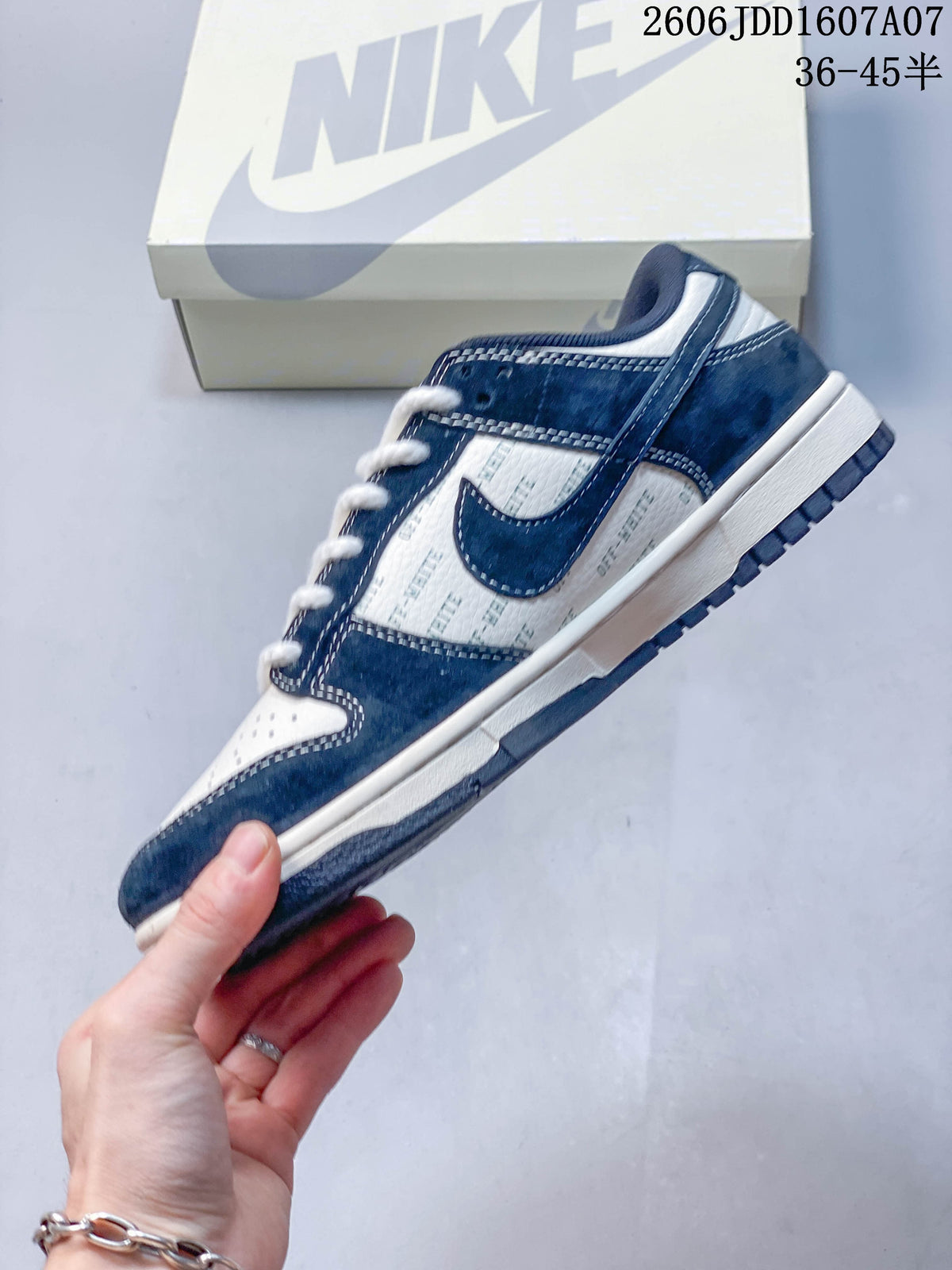Side view of a navy and white Nike SB Dunk Low sneaker with patterned side panels