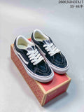Pair of navy and white Vans low-top sneakers displayed on a shoe box