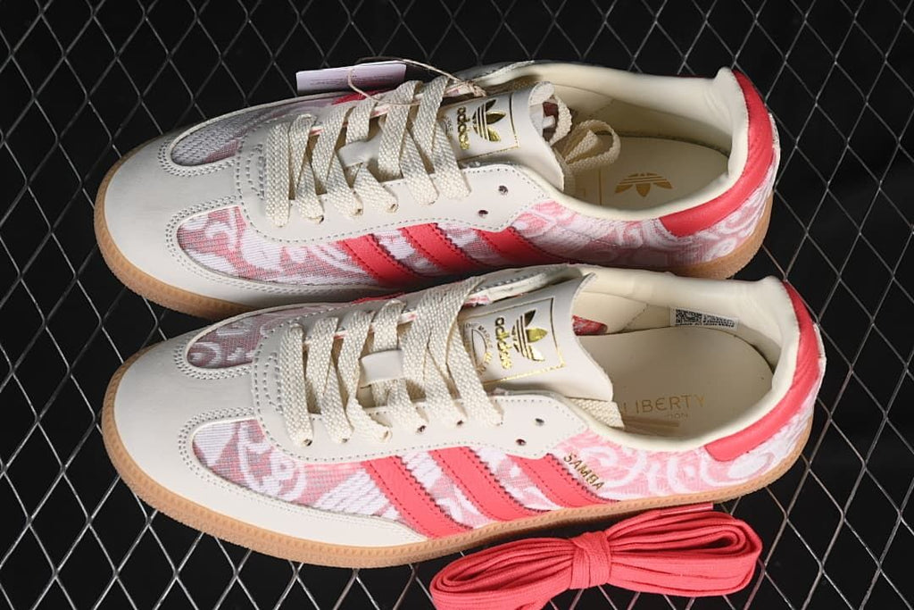 Pair of adidas Samba OG sneakers with an additional coral lace pair
