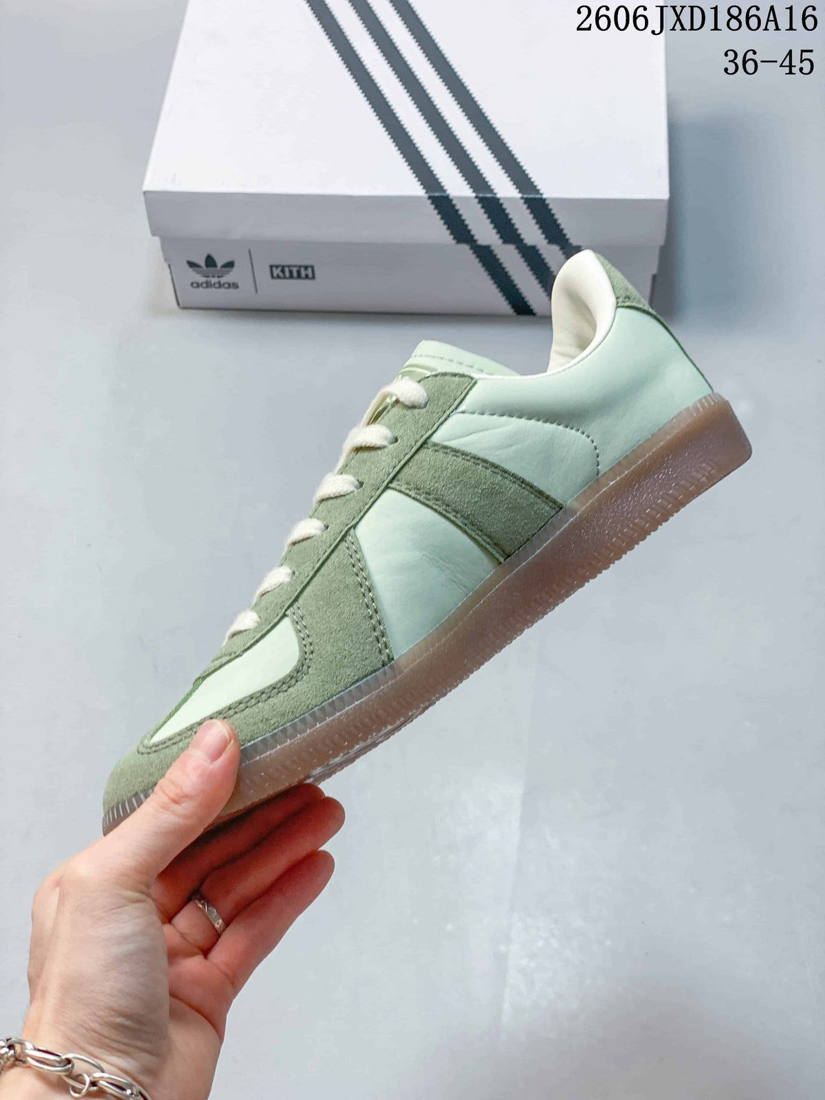 Side view showing pale green panels, darker green overlays, cream laces, and a gum-colored sole.