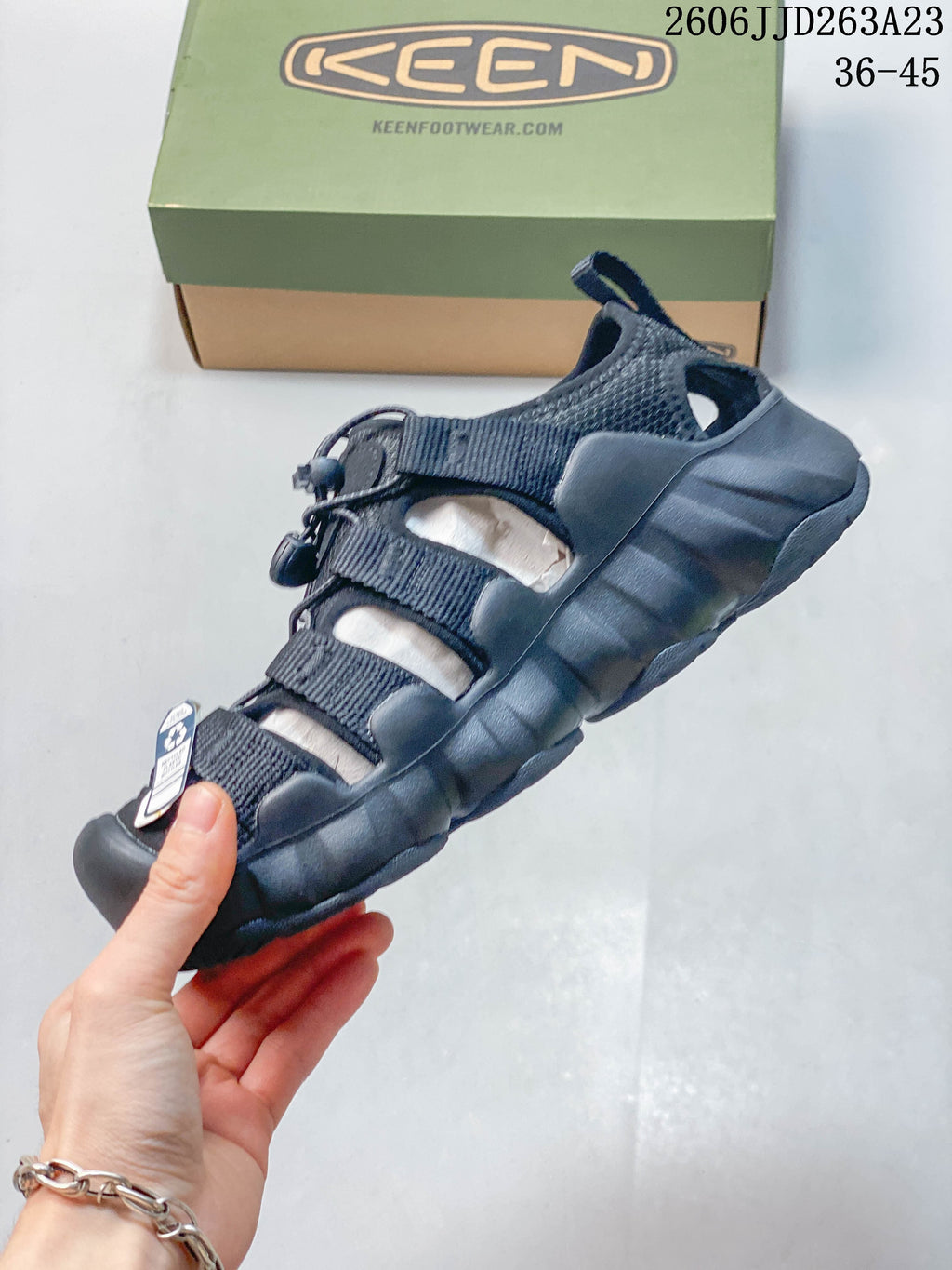 Side profile of the closed-toe sandal with bungee lacing