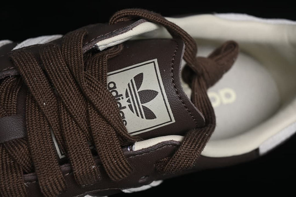 Close-up of the brown laces and adidas Trefoil tongue label