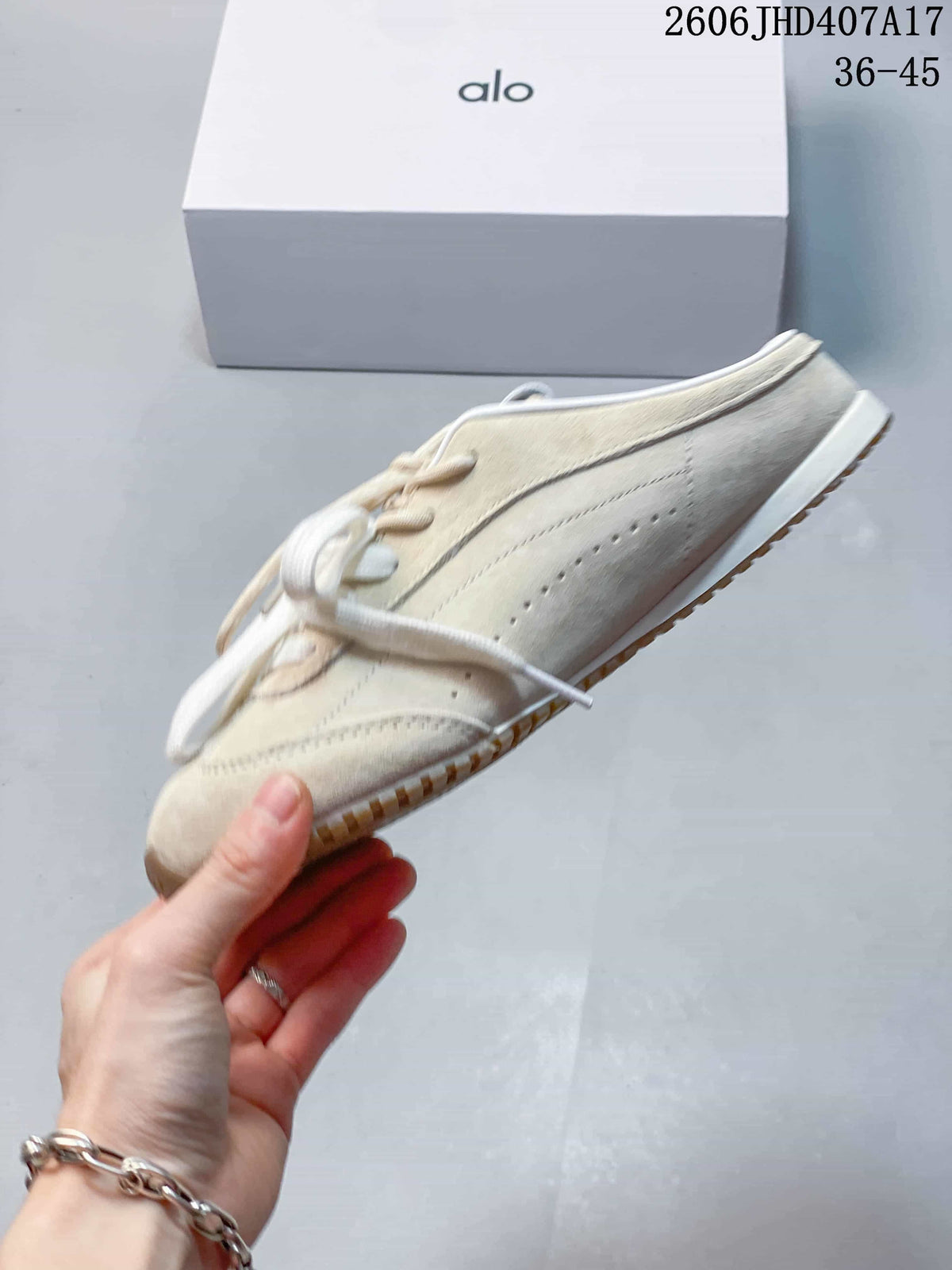 Side view of the cream sneaker with perforated panel details