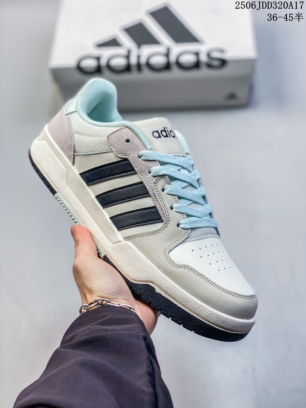 Light-colored adidas Entrap sneaker with black stripes and pale blue details
