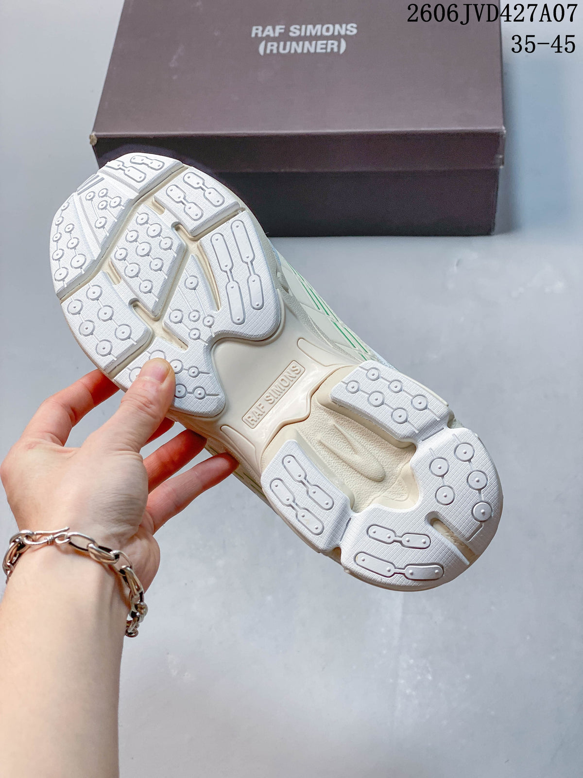 Underside view showing the patterned outsole of a cream Raf Simons sneaker