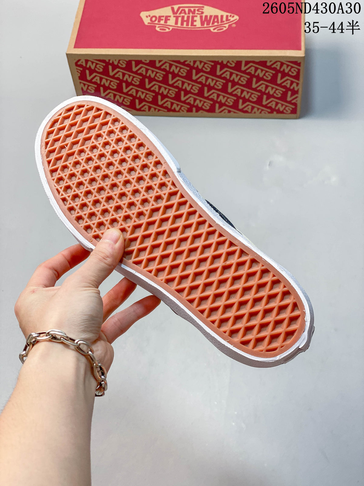 Close-up of the textured outsole on a checkerboard slip-on sneaker.