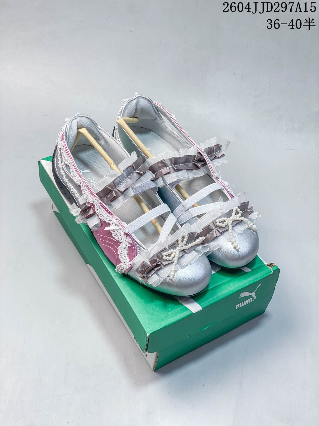 Silver and pink low-profile sneakers with bows, ruffles, and pearl-like trim