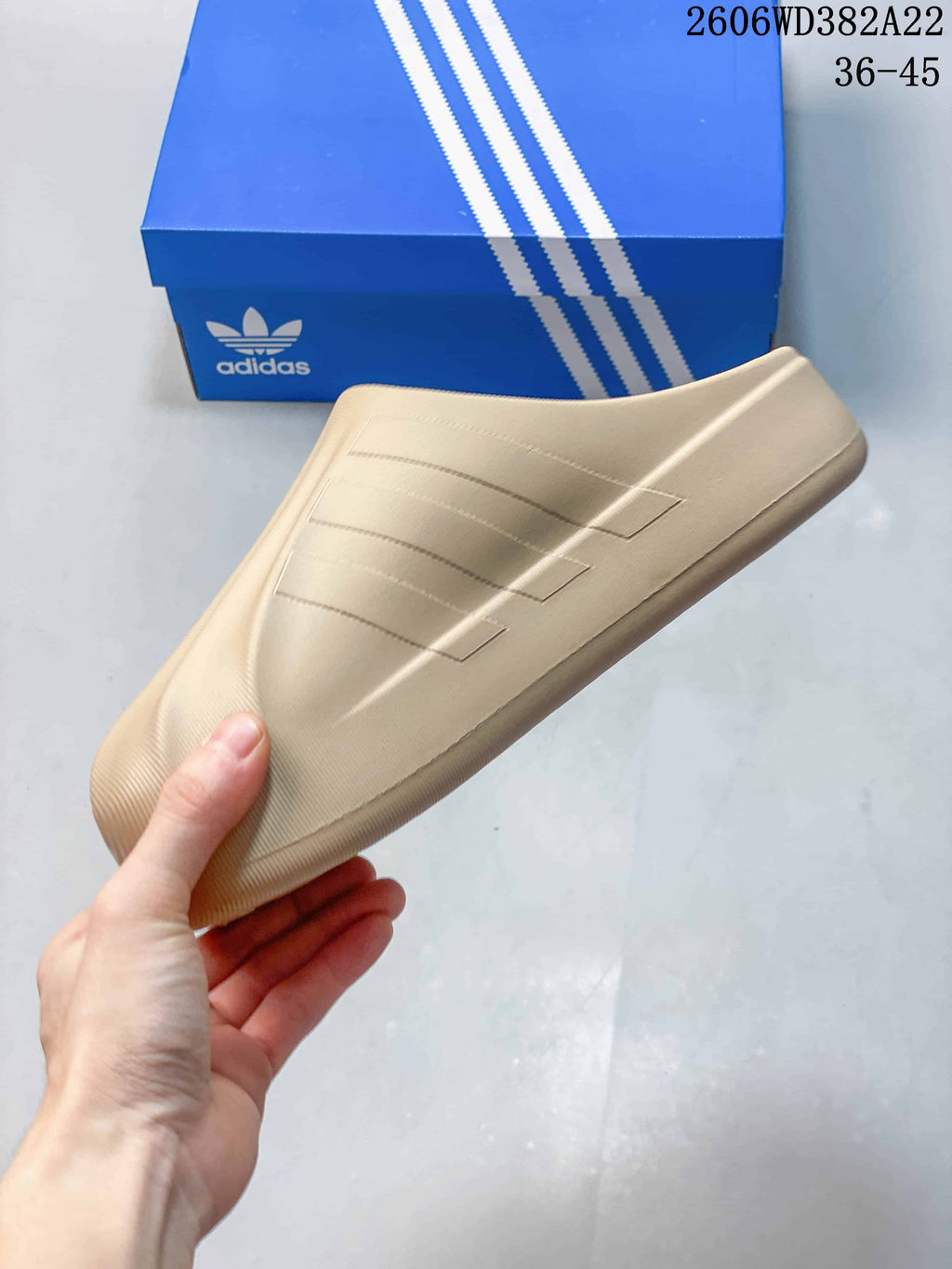 Side view showing the three-bar detail on a beige clog