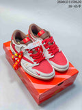 Pair of red, light grey, and brown Air Jordan 1 Low sneakers with decorative tags, shown on a red box.