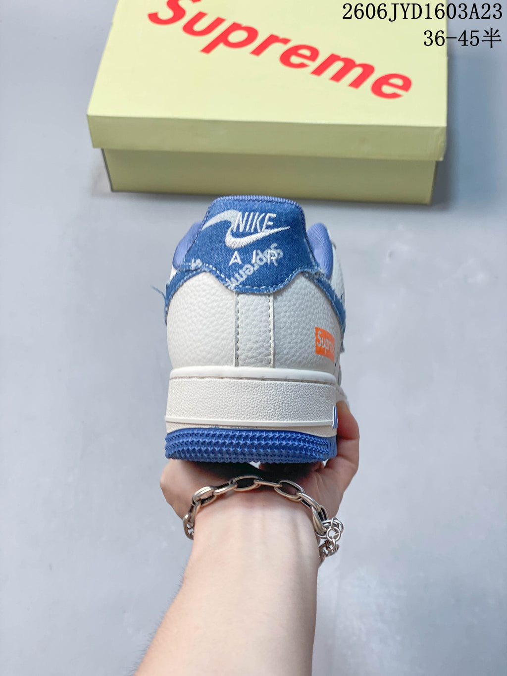 Rear view showing the blue heel panel and white midsole