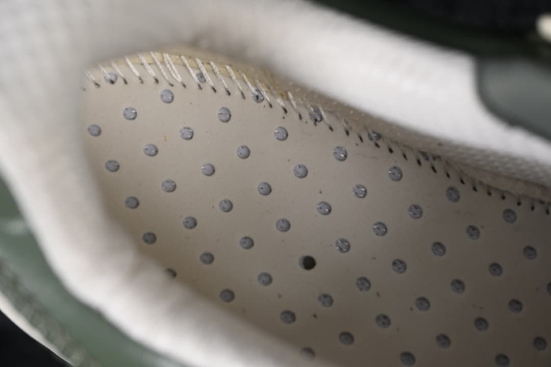 Close-up view inside the sneaker showing a perforated inner surface