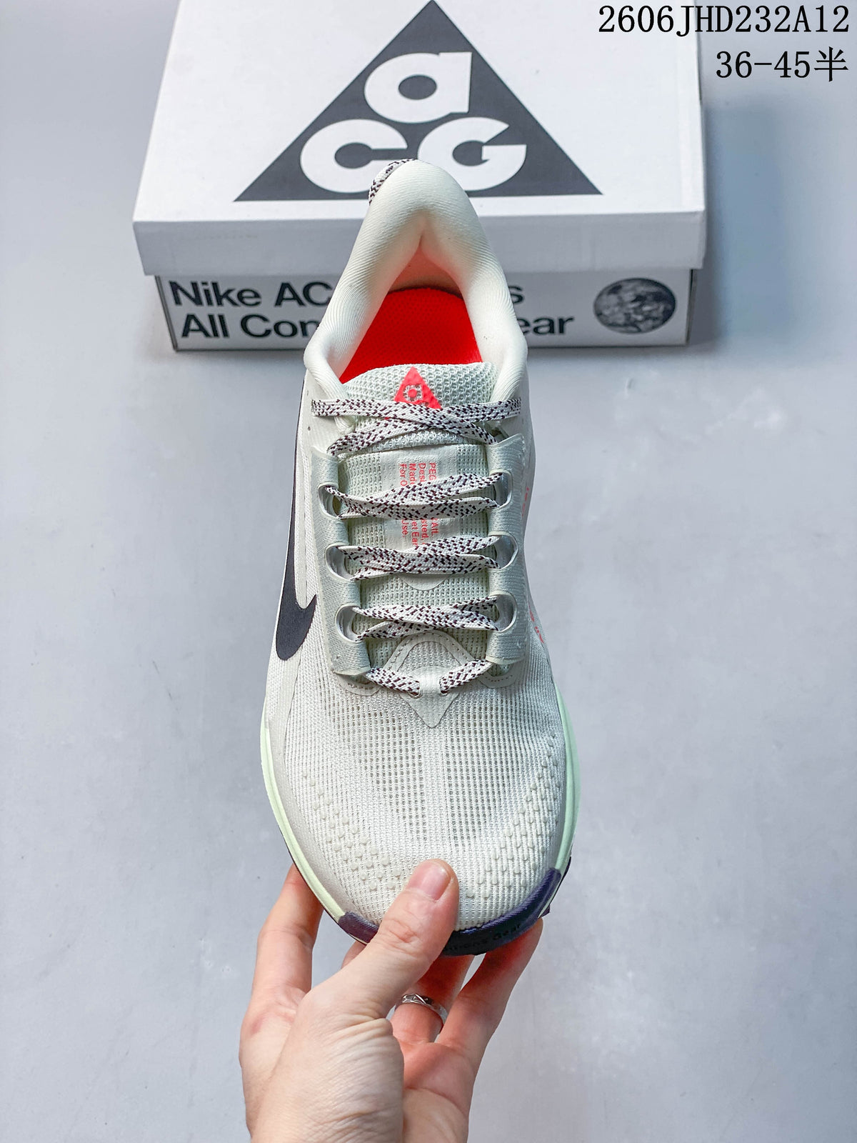 Top view of the Nike ACG Pegasus Trail shoe showing patterned laces and a bright coral interior.