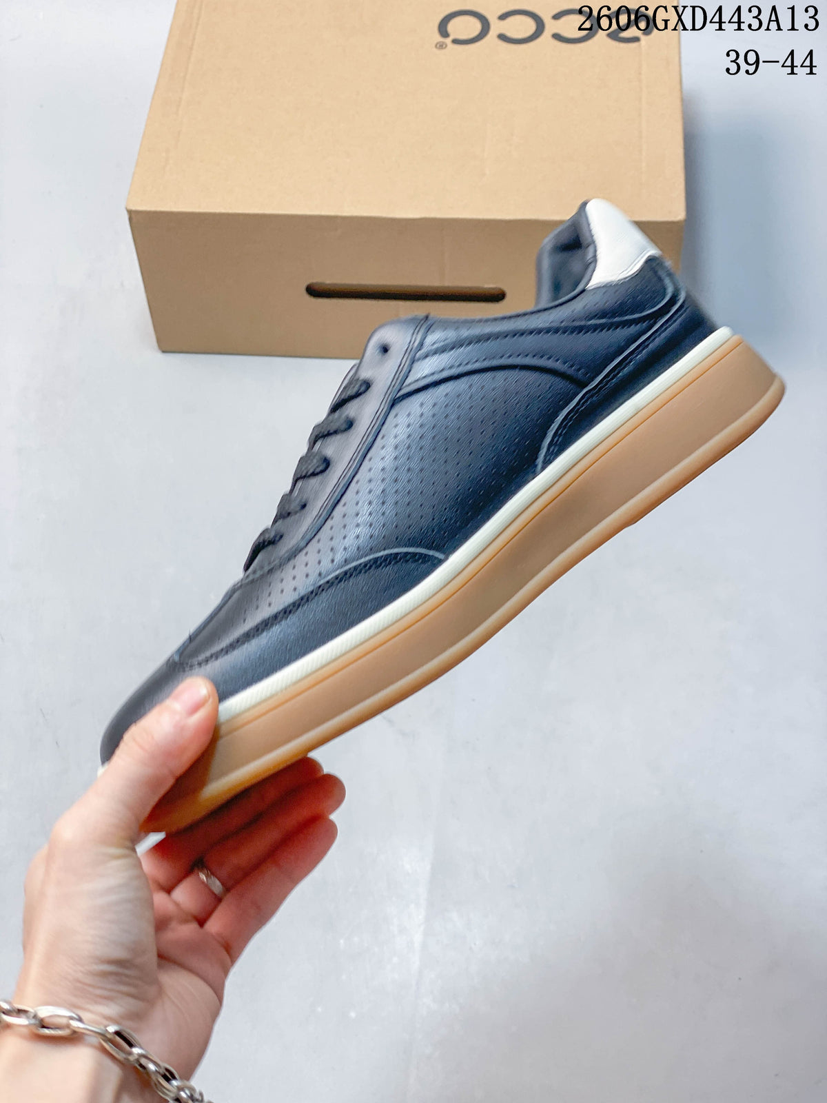 Side profile of a navy perforated low-top sneaker with white trim and gum-colored sole