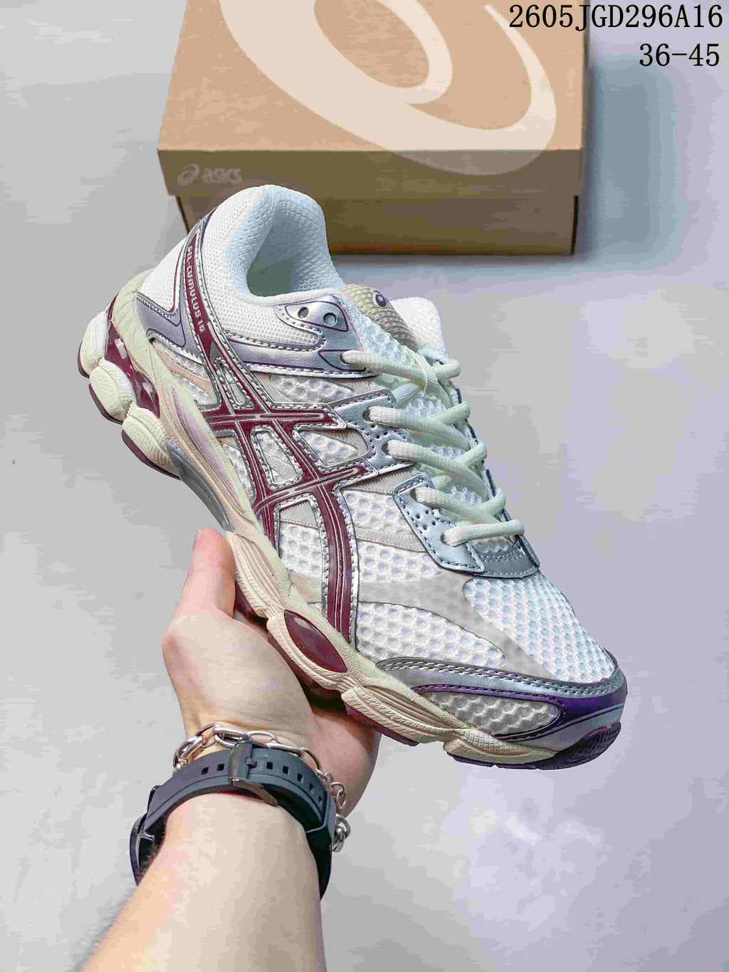 White ASICS Gel-Cumulus 16 sneaker with burgundy and purple accents.