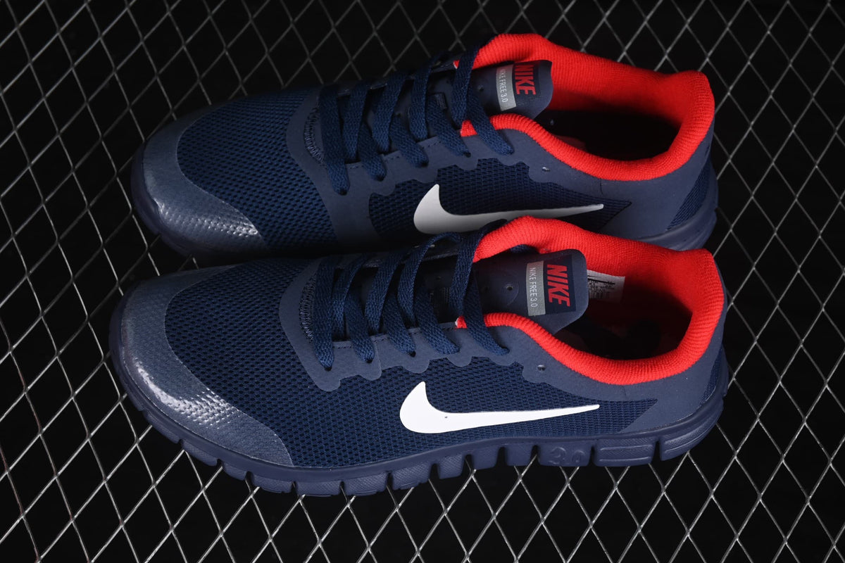 Top-side view of the navy Nike Free 3.0 shoes with white Swooshes and red collar lining.
