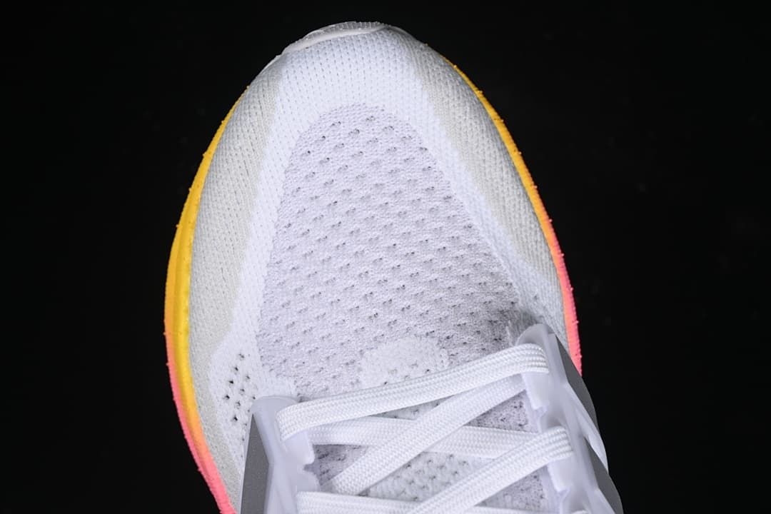 Top view of the white knit-style toe and lacing