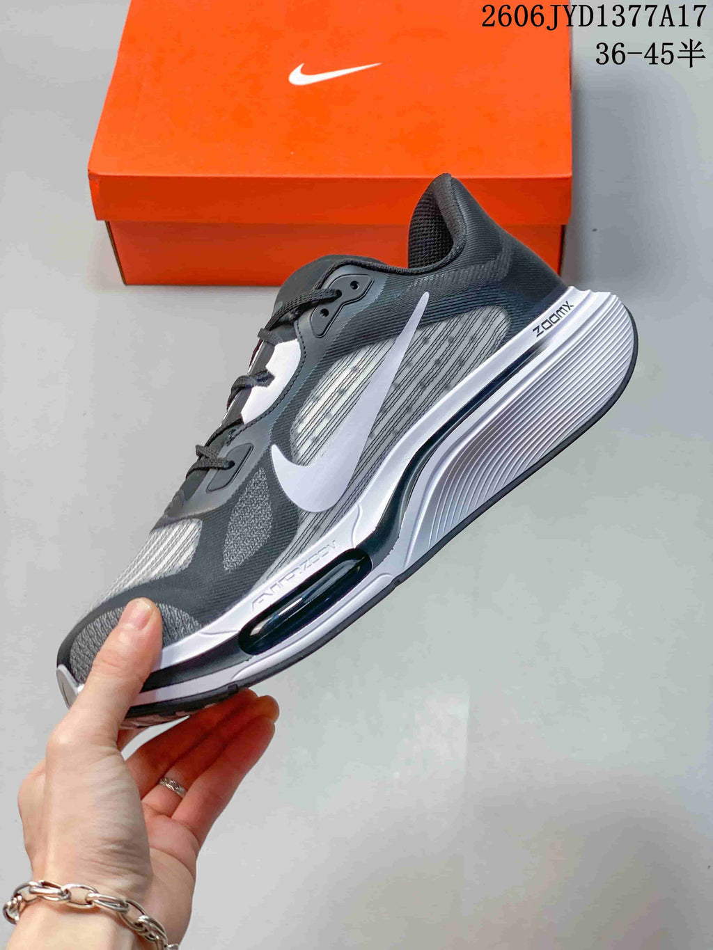 Side profile of the charcoal and white Nike Zoom Plus sneaker with a visible sole window