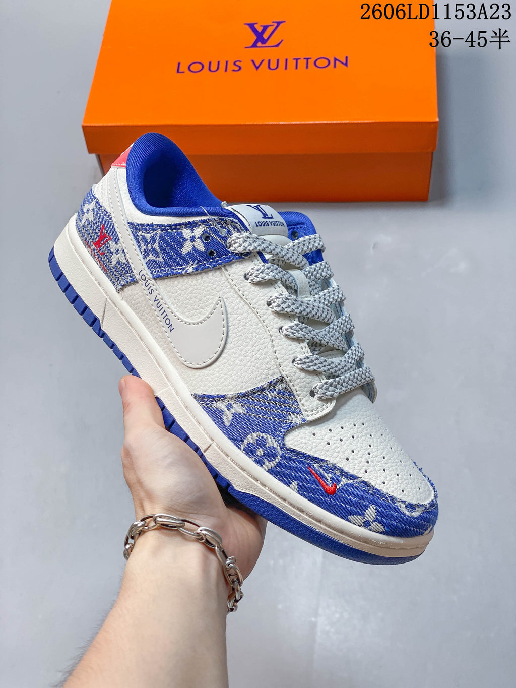Close view of a white low-top sneaker with blue patterned panels and bright blue collar