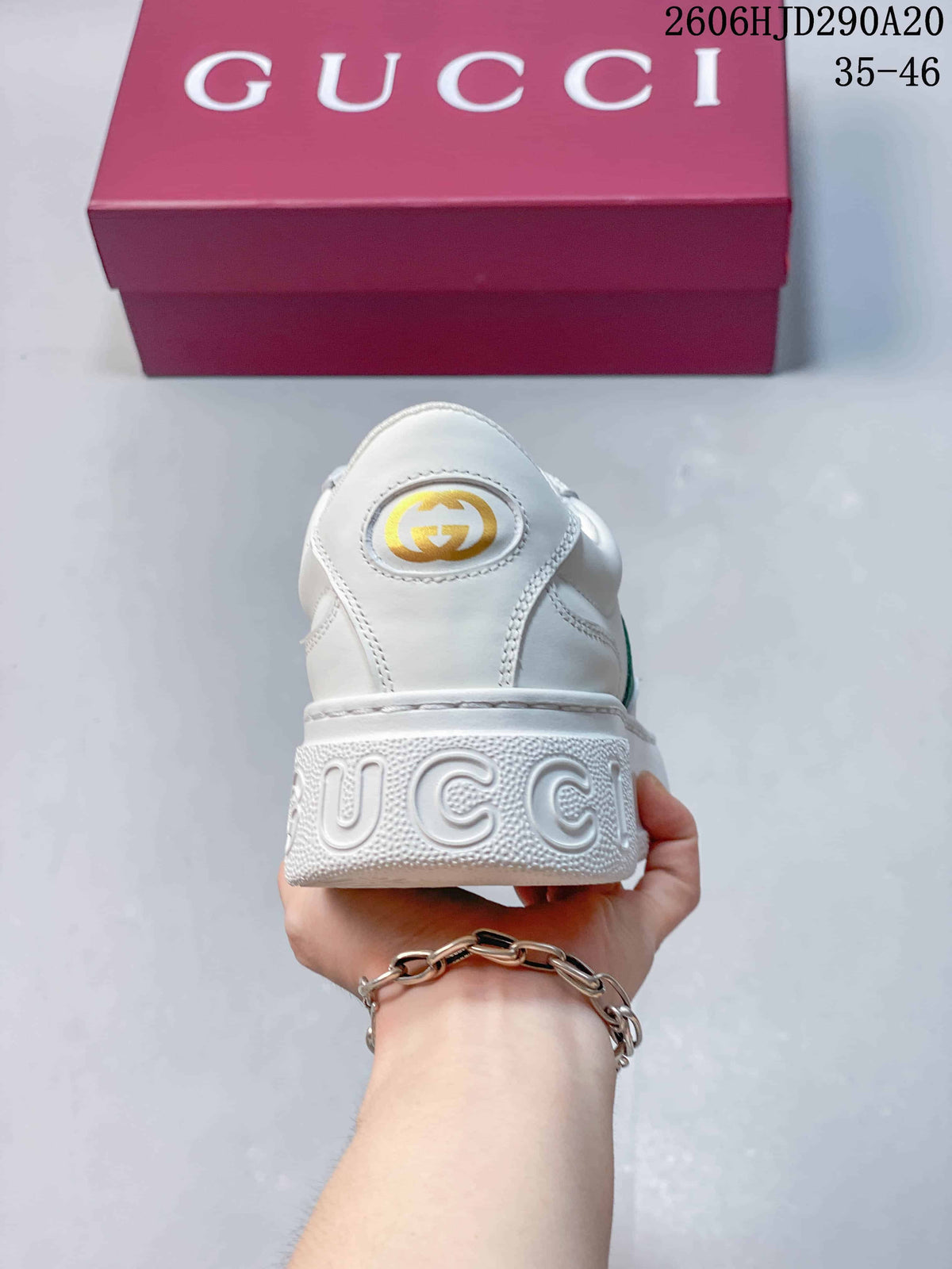 Rear view of the white sneaker with heel branding and a chunky sole