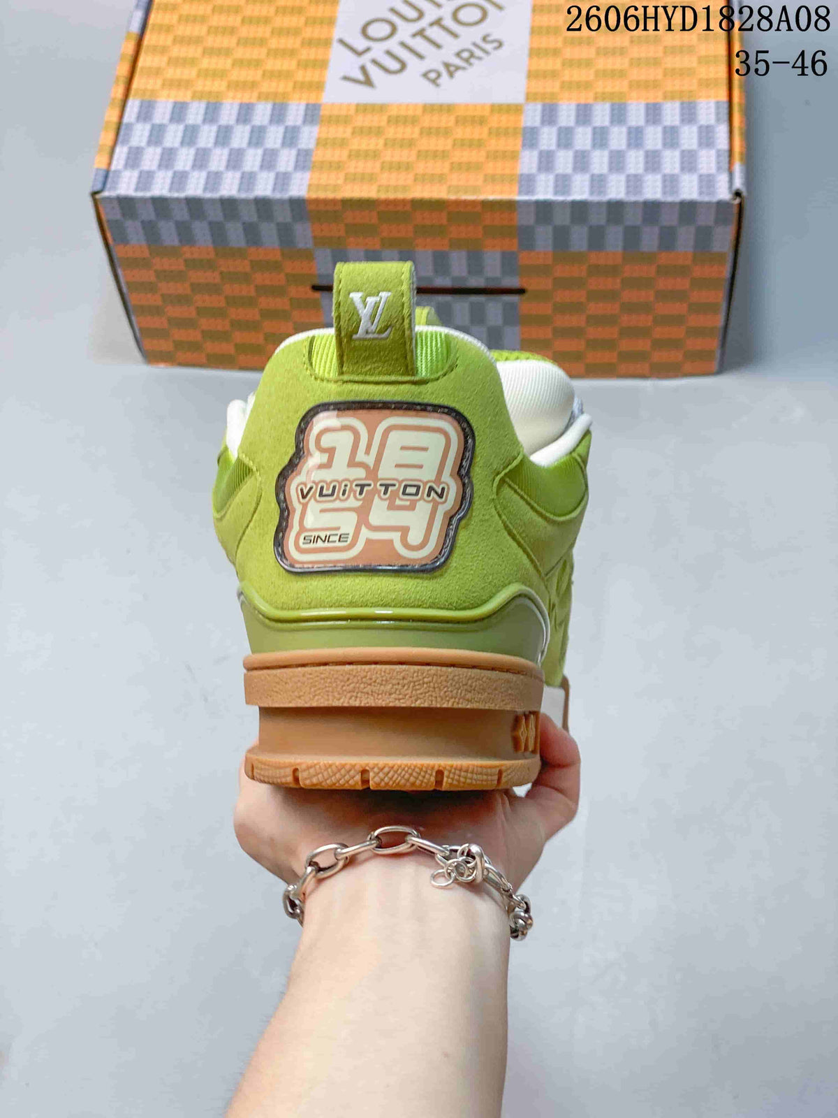 Rear view of the lime-green sneaker with a branded heel patch