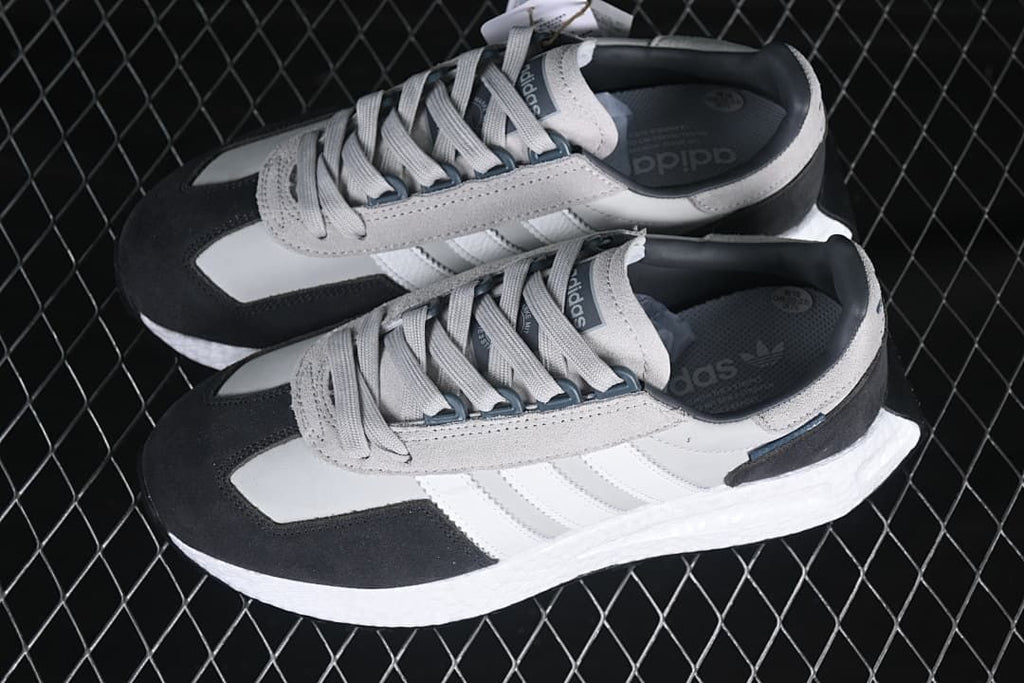 Pair of gray, white, and charcoal Retropy E5 sneakers viewed from above