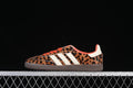Side view of leopard-print Adidas Samba OG W sneakers with cream stripes, orange-red accents, and a dark brown outsole