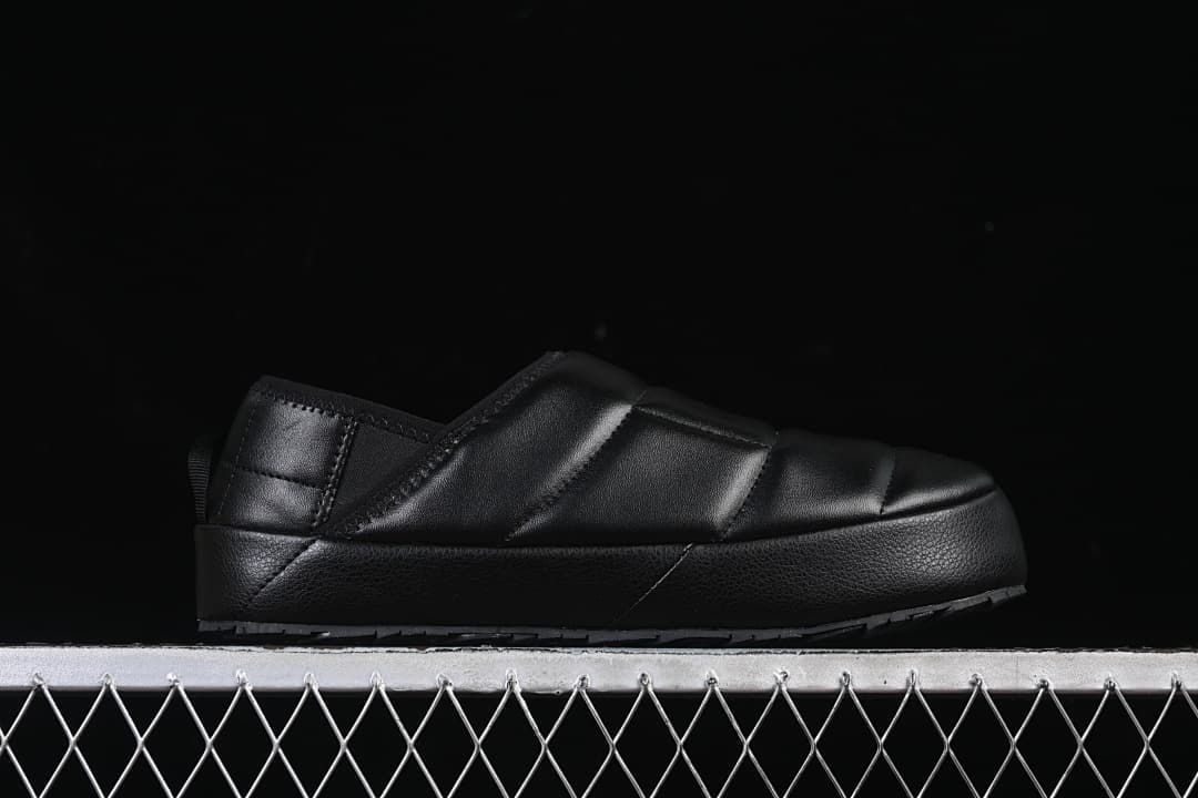 Side profile of the black quilted mule.