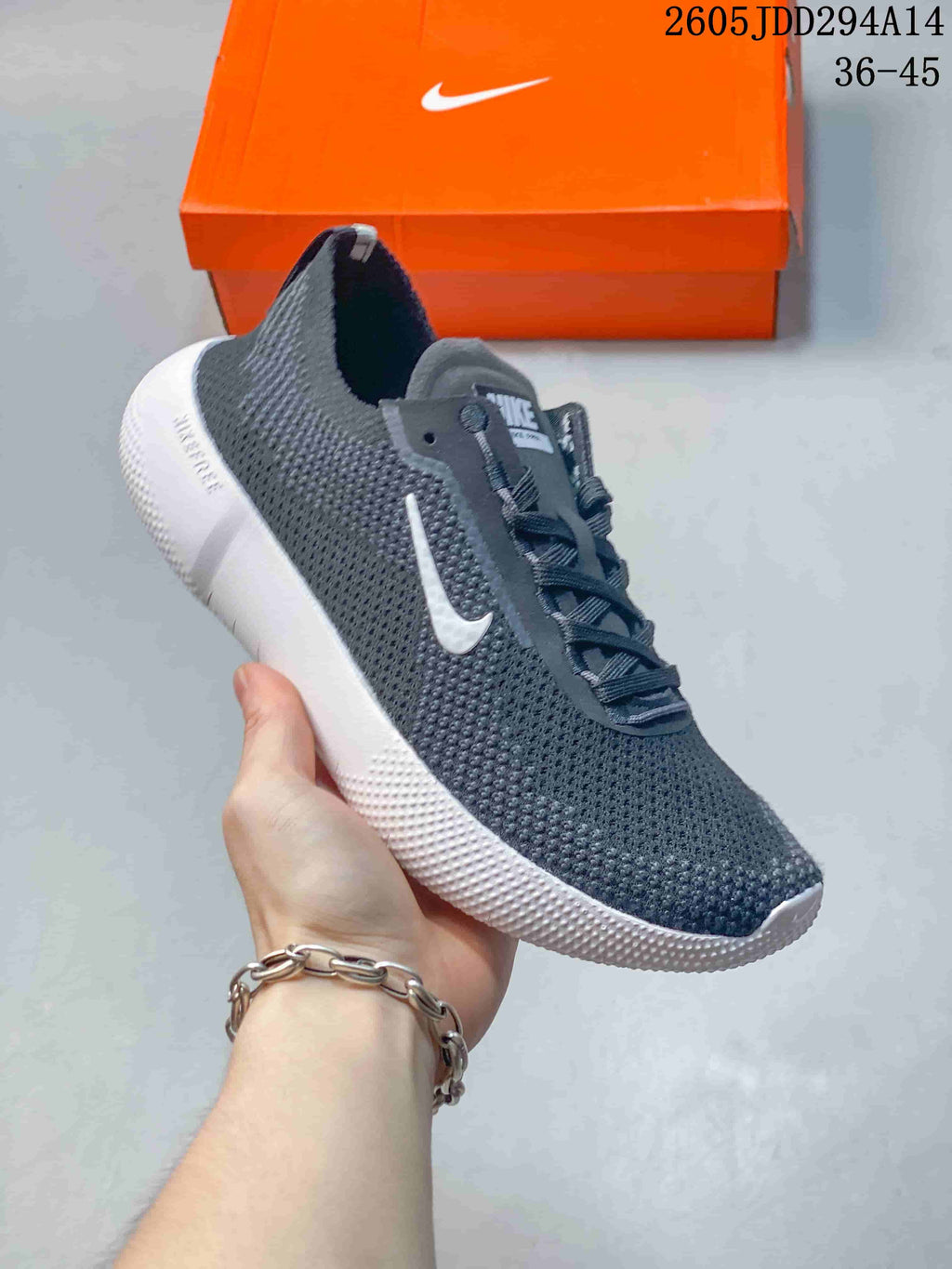 Charcoal gray Nike Free low-top sneaker with a white sole.