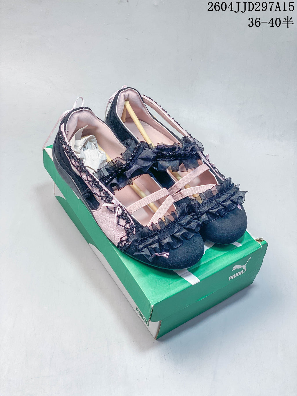 Black and pale pink low-profile sneakers with ruffles and lace trim
