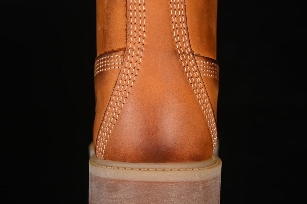 Rear view showing stitched heel panels and lugged outsole