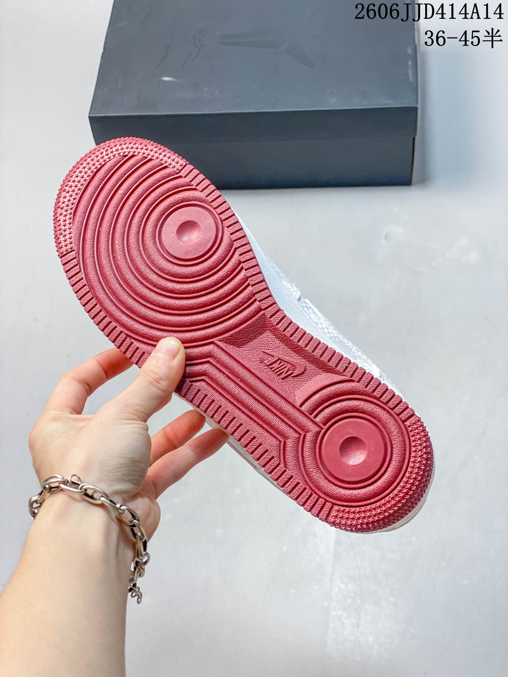 View of the sneaker's burgundy-red outsole with circular tread patterns