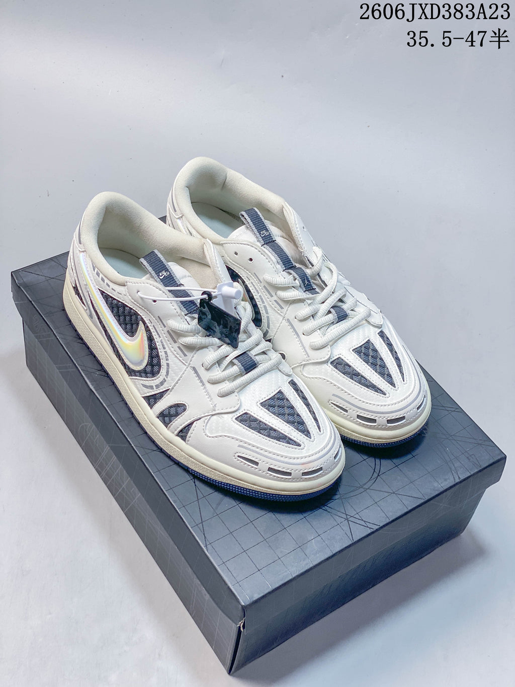 Pair of off-white and slate-blue Air Jordan 1 SE Low sneakers on a shoebox