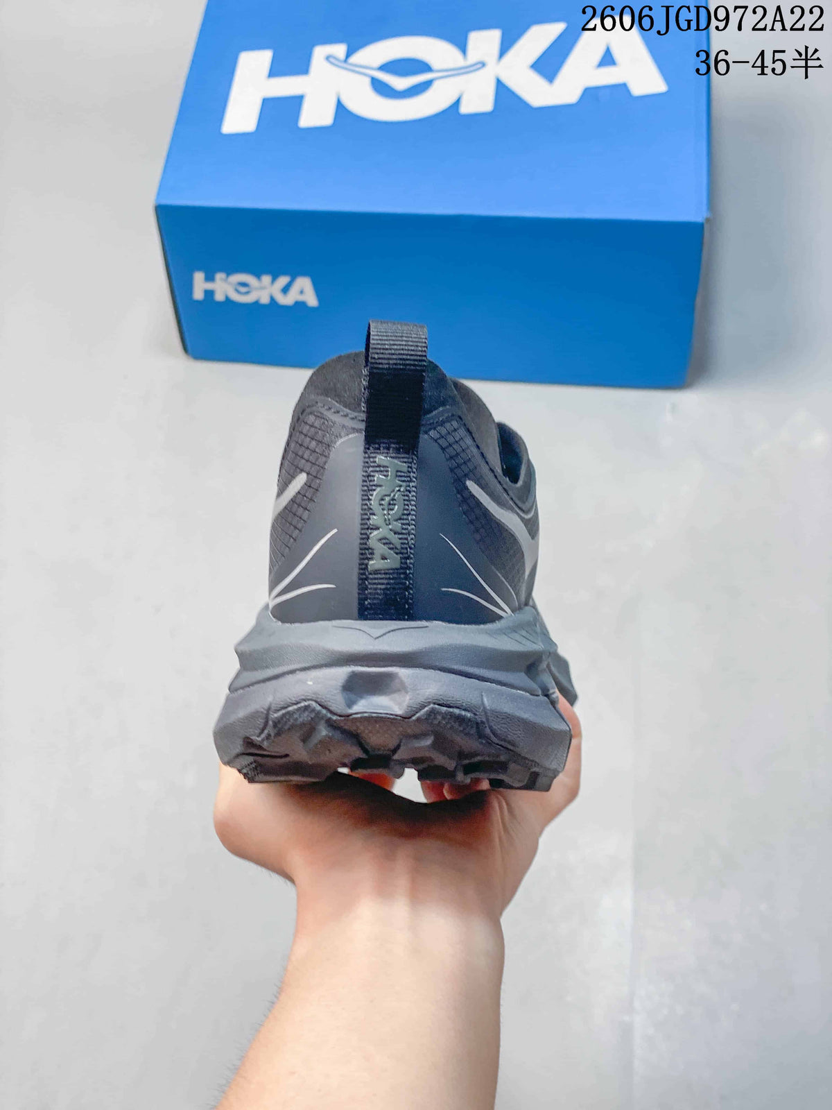 Rear view showing the heel and outsole of a charcoal-gray HOKA shoe