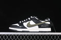 Side view of a black, white, and olive Nike SB Dunk Low sneaker with a long lace detail at the heel