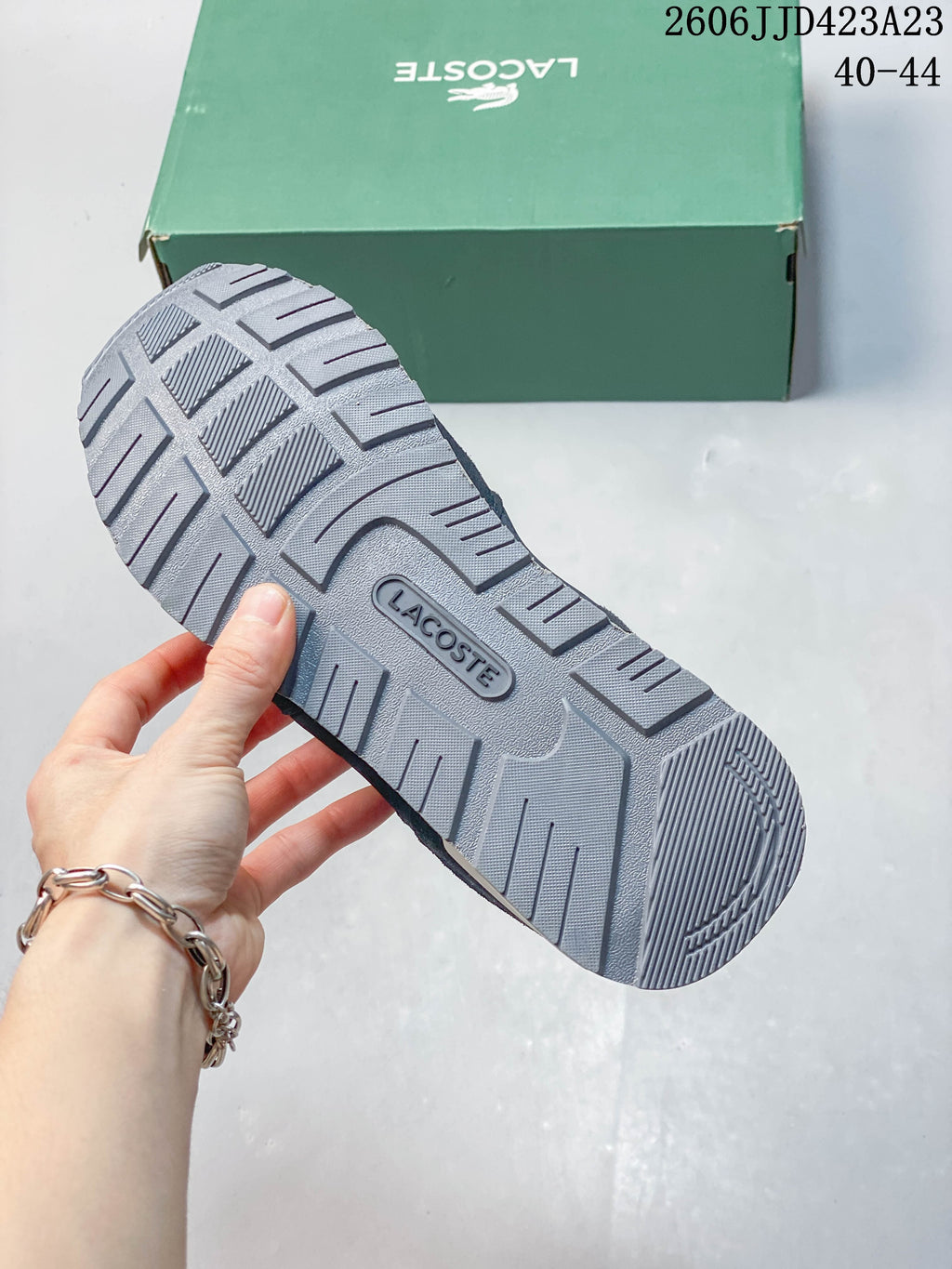 Close-up of the patterned gray outsole on a Lacoste sneaker.
