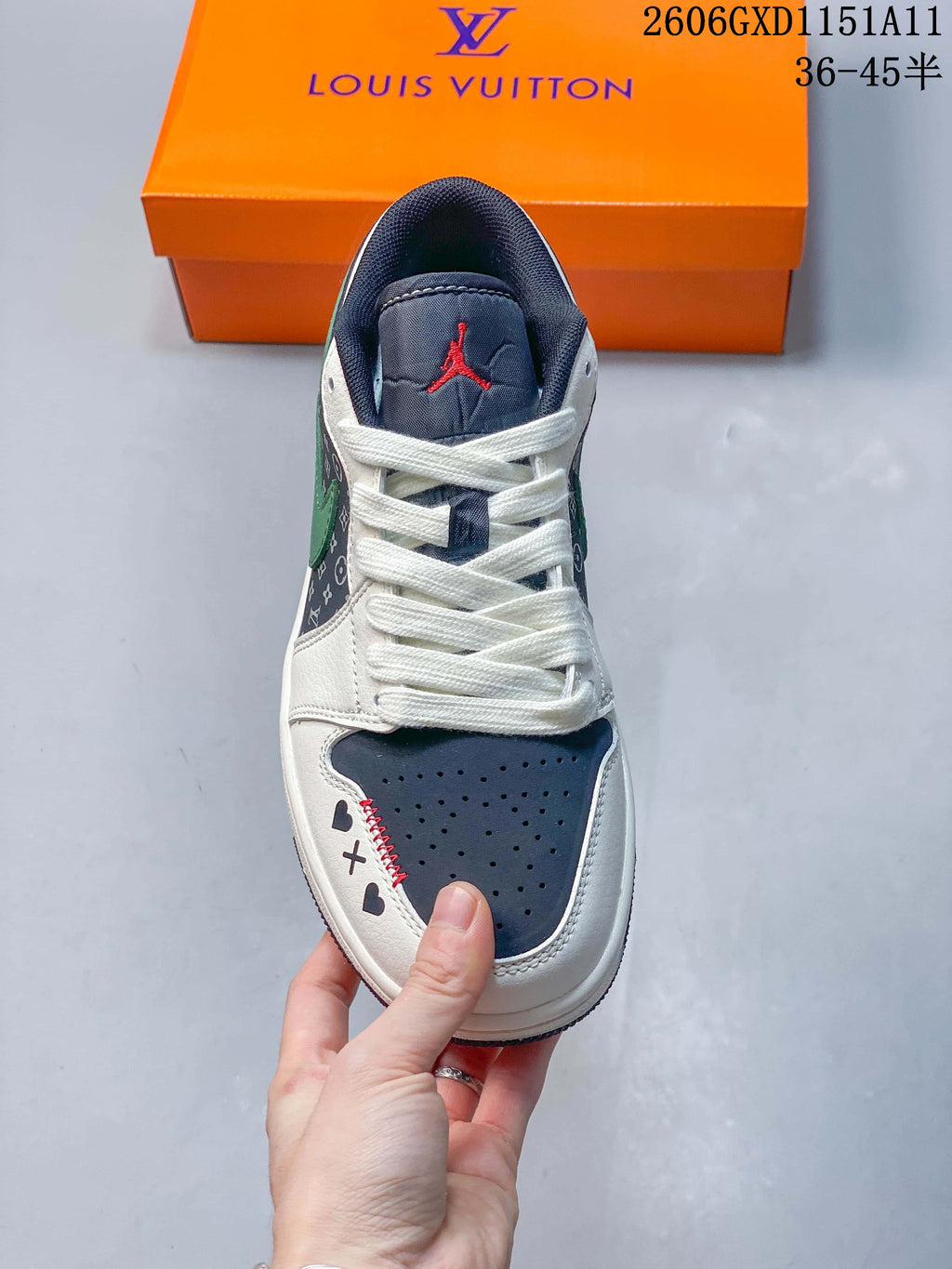 Top view showing the perforated navy toe, white laces, and heart and cross details.