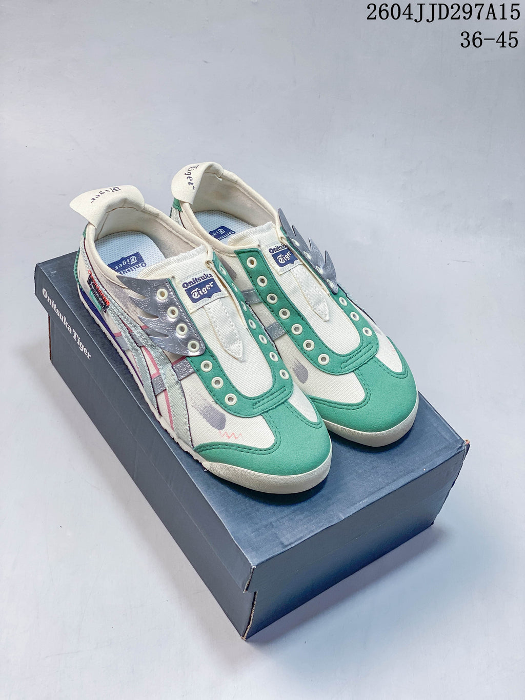 Pair of off-white and green Onitsuka Tiger Mexico 66 slip-on sneakers on a shoebox