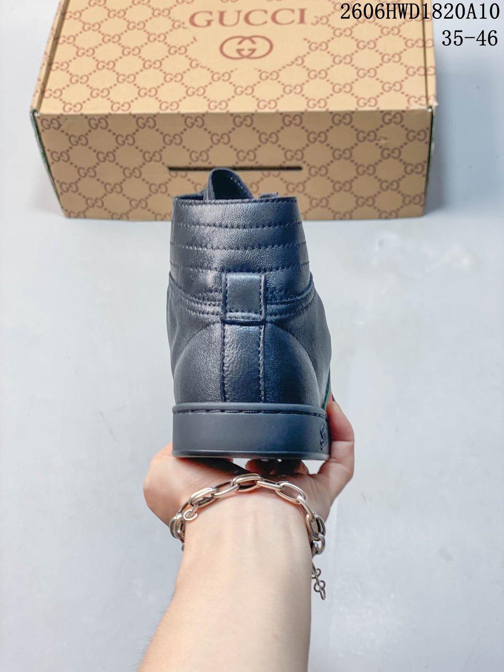 Rear view of a dark gray high-top sneaker showing the heel and padded collar.