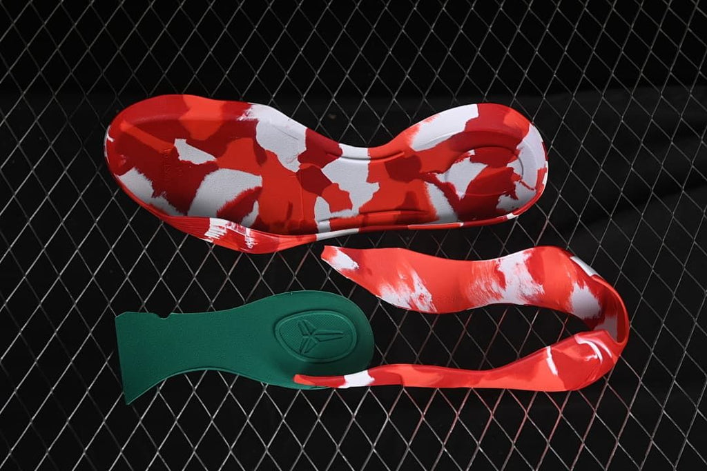 Detached shoe components showing red, white, and green details