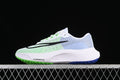 Side view of white Nike Zoom Fly 5 running shoe with green and blue accents and black Swoosh
