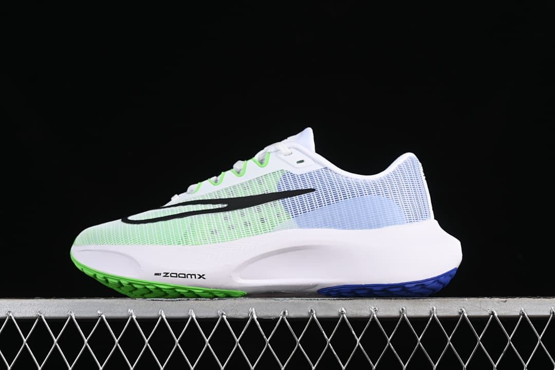 Side view of white Nike Zoom Fly 5 running shoe with green and blue accents and black Swoosh