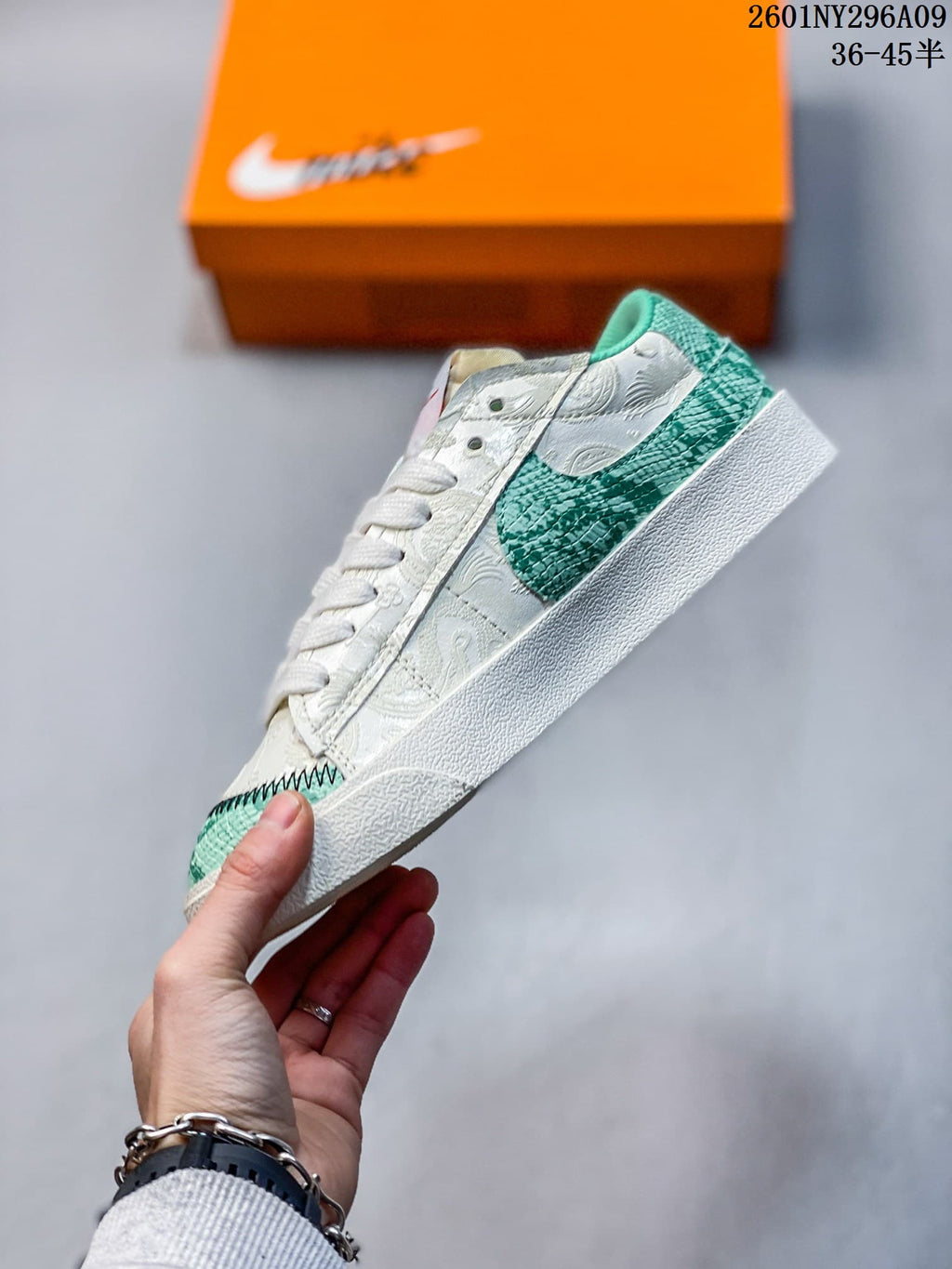 Side view of the white low-top sneaker with a large green Swoosh and patterned panels.