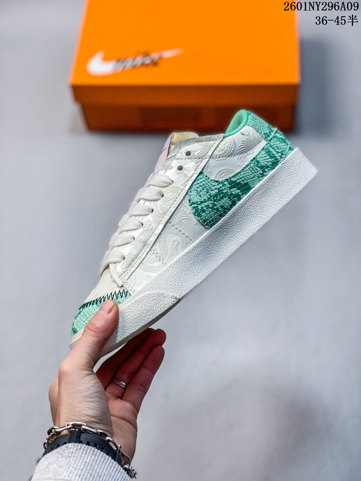 Side view of the white low-top sneaker with a large green Swoosh and patterned panels.