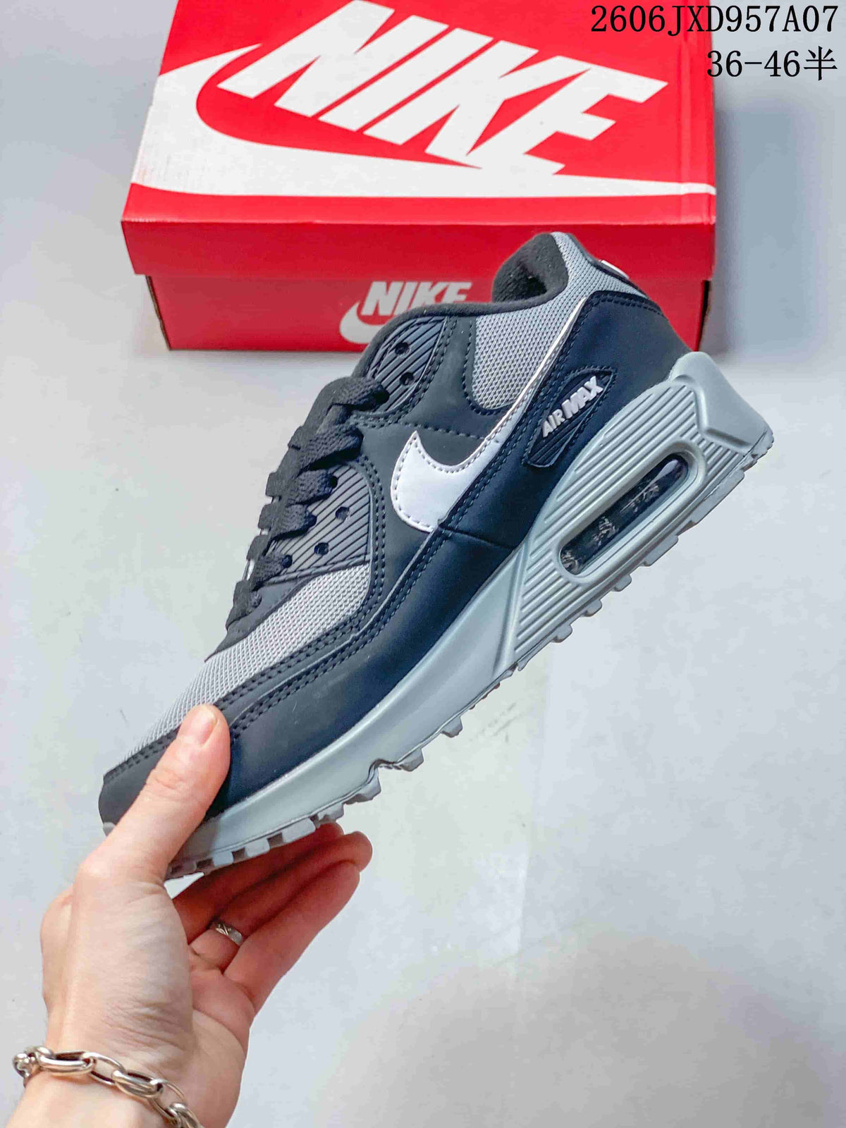 Side view of a navy and gray Nike Air Max 90 sneaker with a white Swoosh and visible Air unit.