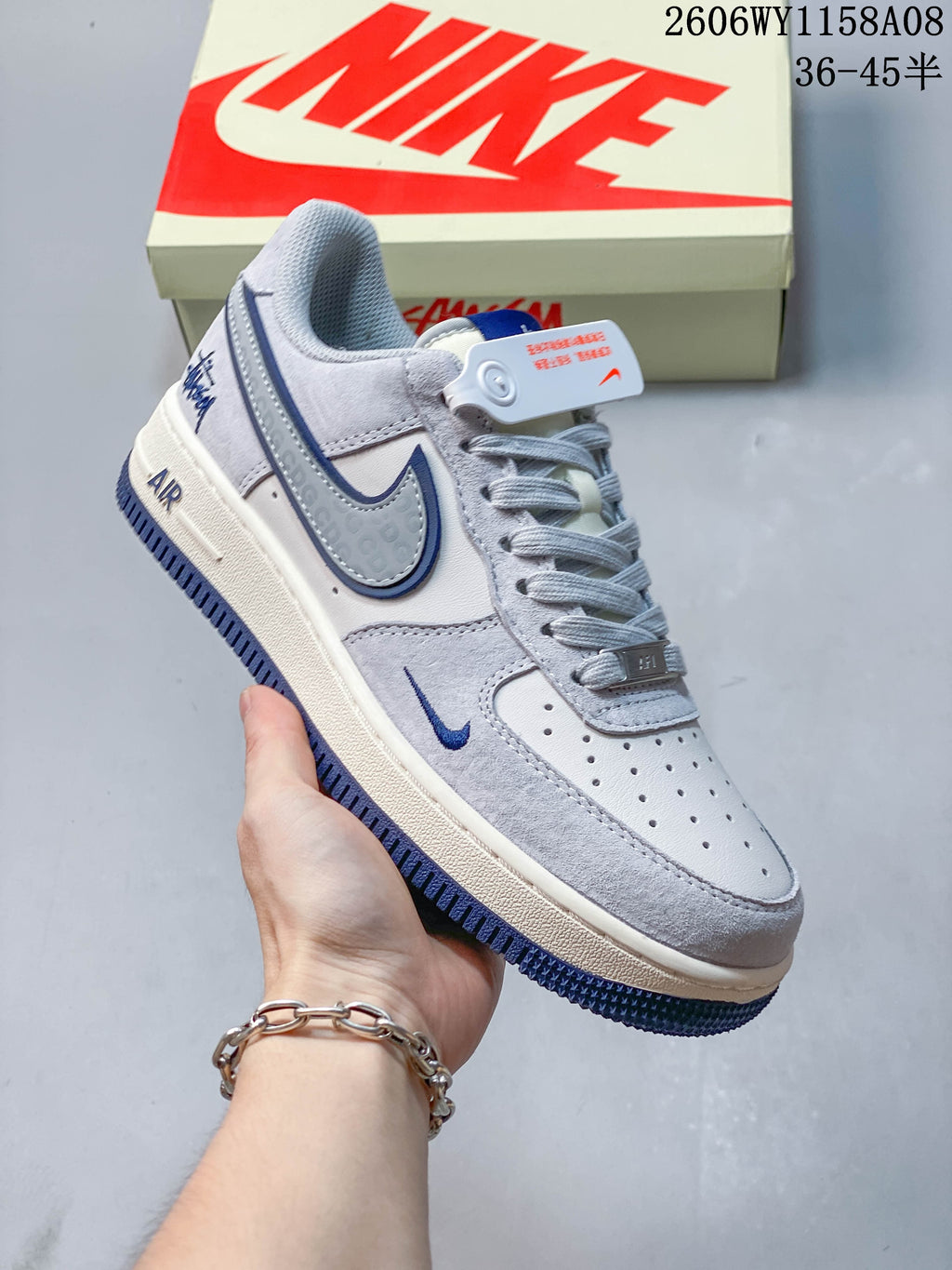 Angled side view of a gray Nike Air Force 1 '07 sneaker with blue accents