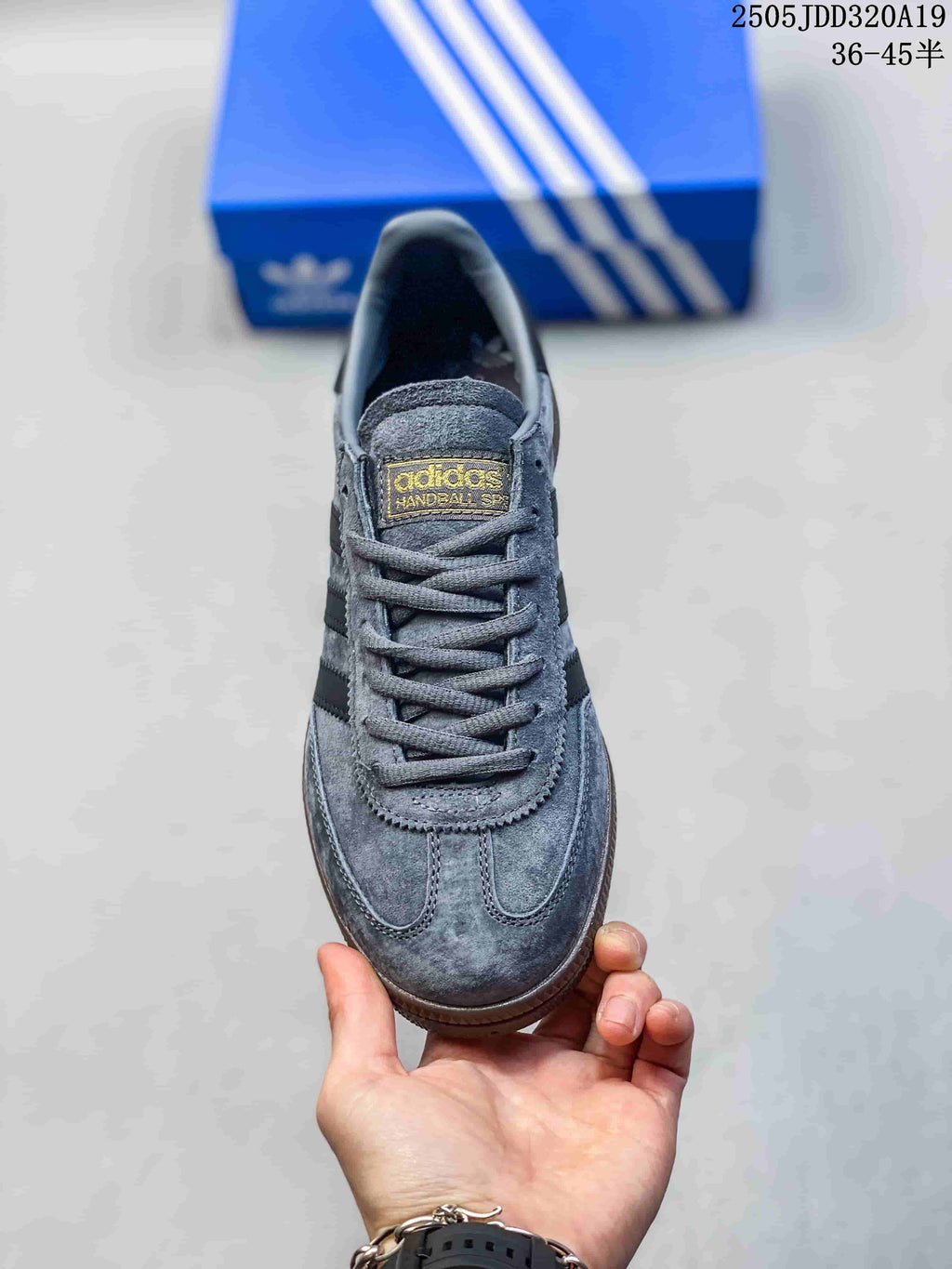 Top view of a grey lace-up sneaker with a gold-tone tongue label.
