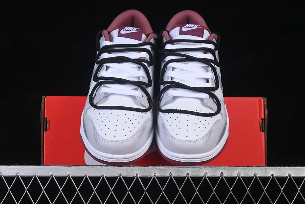 Front view of the pair showing perforated toe boxes and layered black cord-style straps