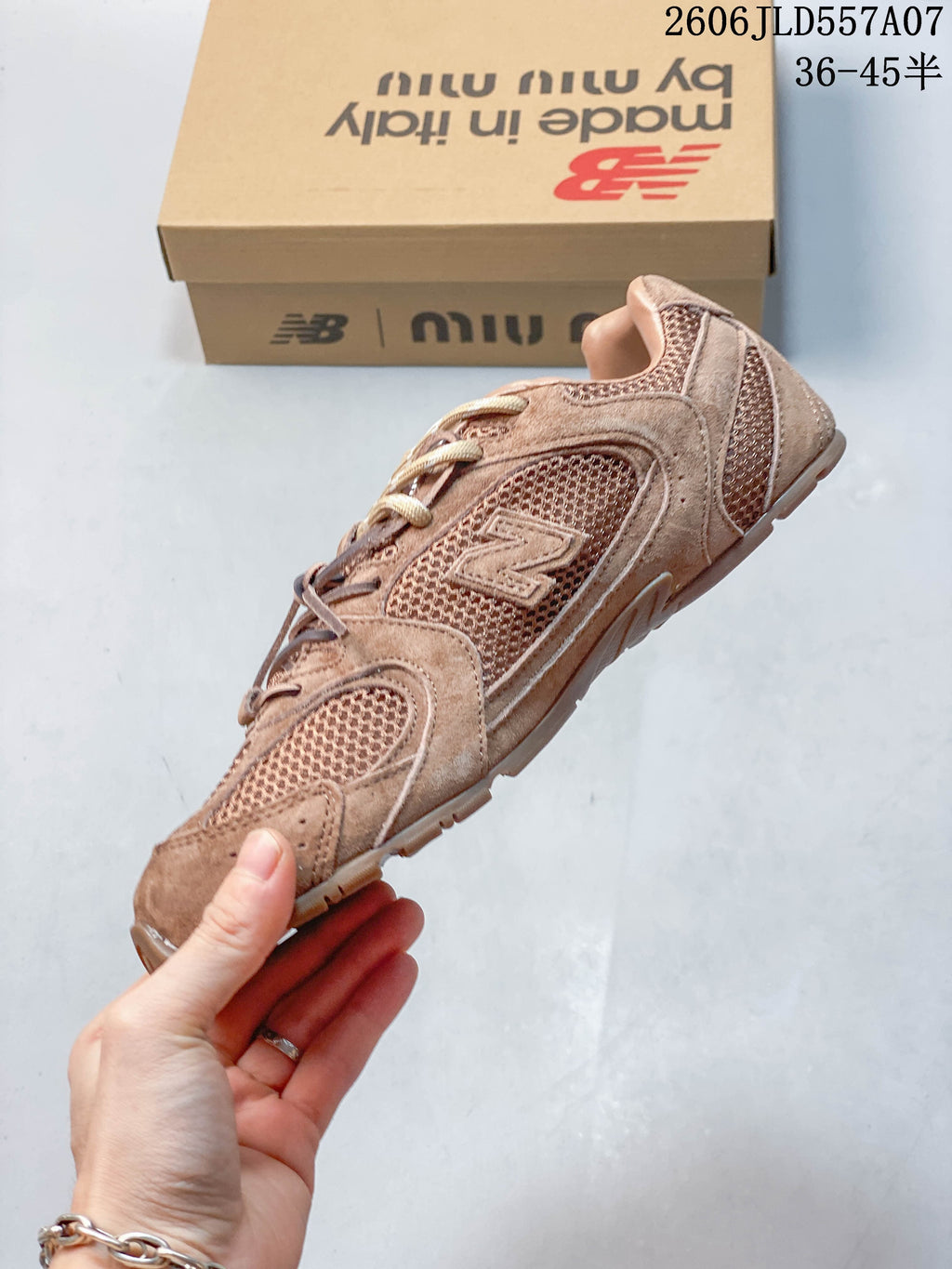 Side view of the brown-toned sneaker with mesh panels and a side logo.